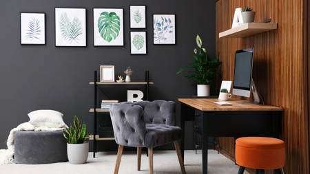 office interior design iMac velvet furnishings and framed prints on grey wall