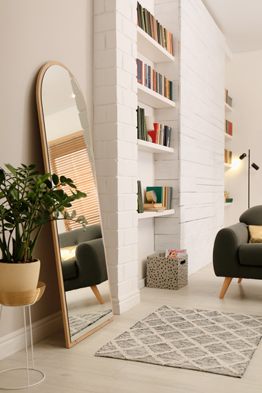 modern front room interior and leaning wall mirror